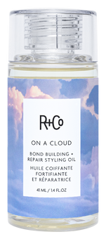 R+Co styling oil bottle with cloud design on label